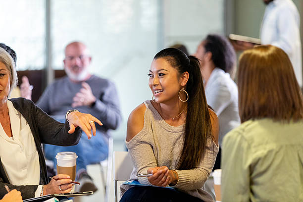 istock Diverse group of people engaged in conversation during an indoor meeting or support session. 2242845834