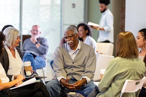 istock Diverse group of adults in a discussion circle, sharing experiences and offering support. 2242845846