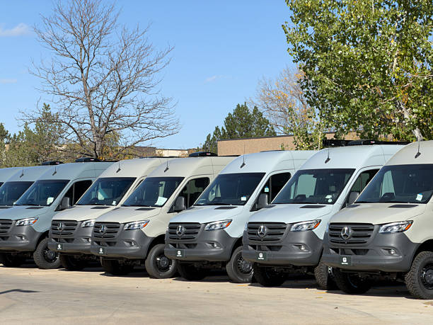 Boulder, Colorado, USA - October 18, 2025: Fleet of Mercedes-Benz Sprinter vans parked together in a row under a clear sky