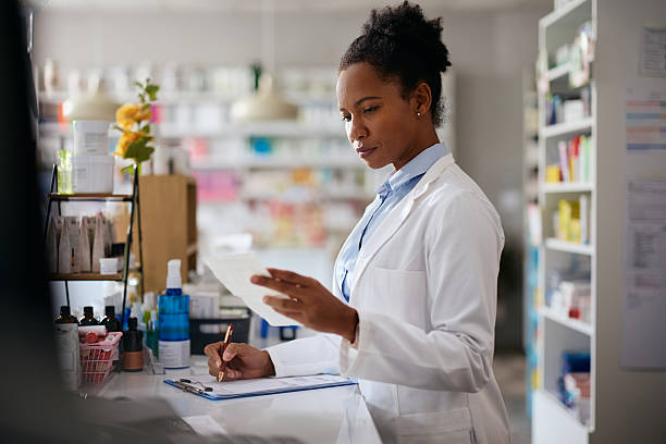 istock Black female pharmacist taking notes while analyzing a prescription in a pharmacy. 2242851165