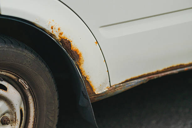istock Close up of rusty white car fender damage.. 2242853388