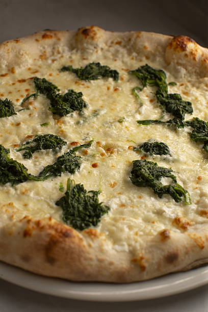 istock Delicious Cheese Pizza Served with Fresh Greens on a Plate for Enjoyment 2242855121