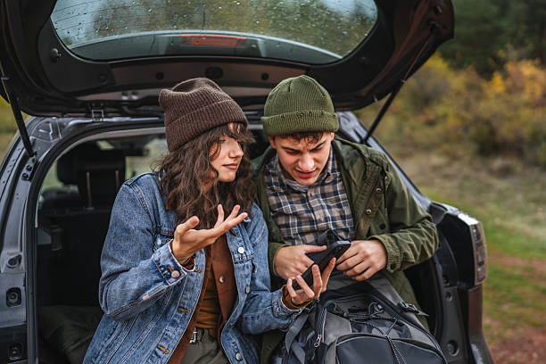 istock Young couple arguing looking at smart phone for navigation 2242861092