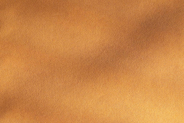 istock Gradient golden brown wallpaper background texture with creases 2242861293