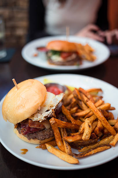 istock Gourmet Burger with Bacon and Egg Served with Crispy Fries 2242862308