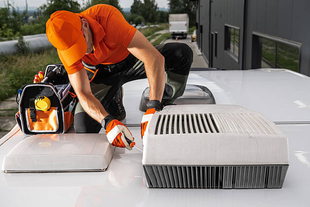 istock Tech Repairs RV Camper Van Rooftop AC Unit at Commercial Building 2242864317