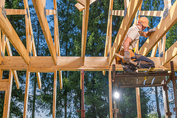 istock Carpenter Works on Wooden Framework at Construction Site in Daylight 2242864655