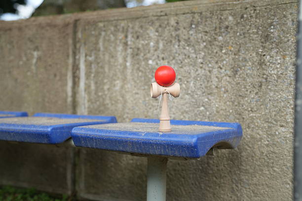 istock A wooden toy is sitting on a blue bench 2242867424