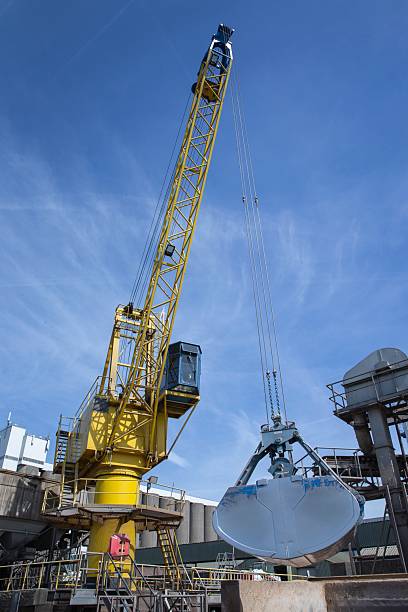 istock Unloading a barge with soy a crane in the harbor at a river. 2242867741