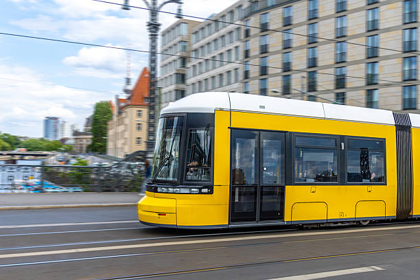 istock Yellow tram moving through city streets. Modern mobility and dynamics. 2242867848