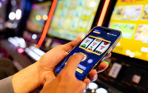 istock Man playing a casino game using an app on a mobile phone 2242868135