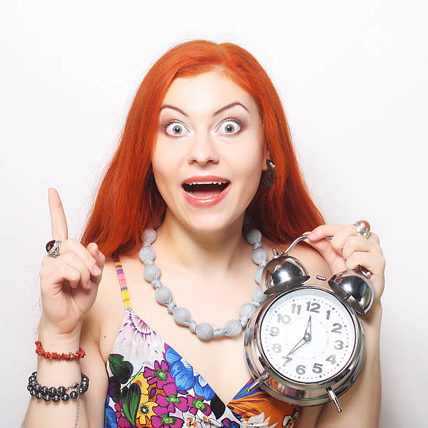 Young fun woman with alarmclock