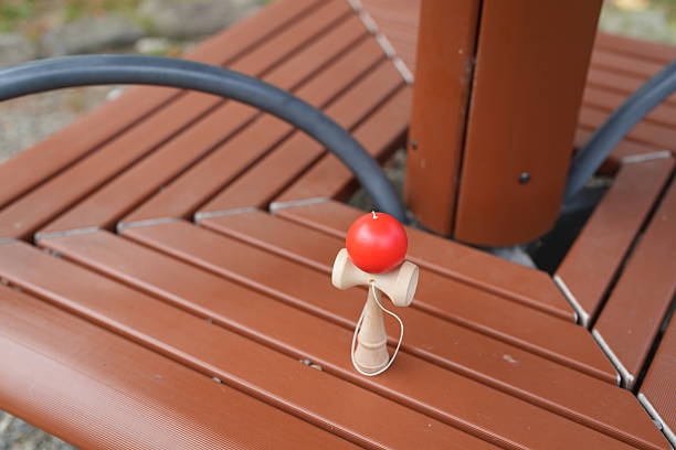 istock A wooden ball is sitting on a brown bench 2242869483