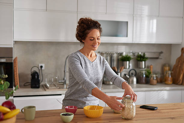 istock Woman preparing healthy oatmeal breakfast in modern kitchen 2242869628