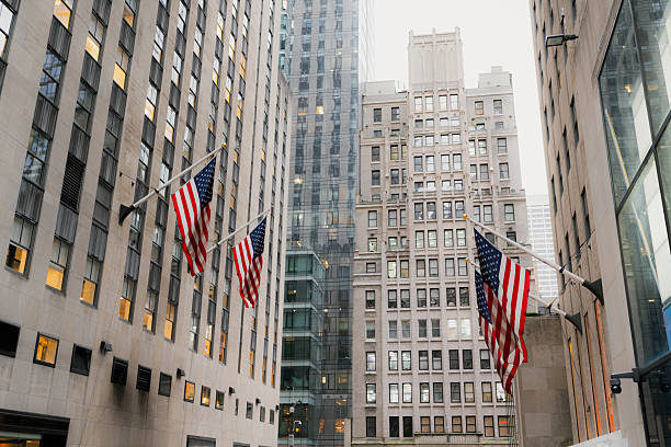 istock American flags flying on manhattan city buildings 2242869702