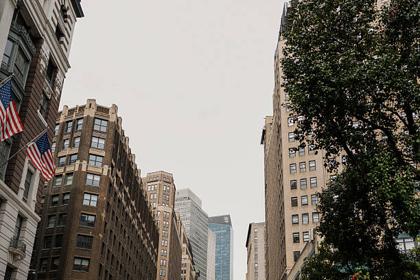 istock Looking up at manhattan buildings and american flag 2242869800