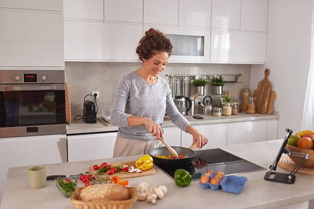istock Woman cooking fresh healthy meal in kitchen 2242871036