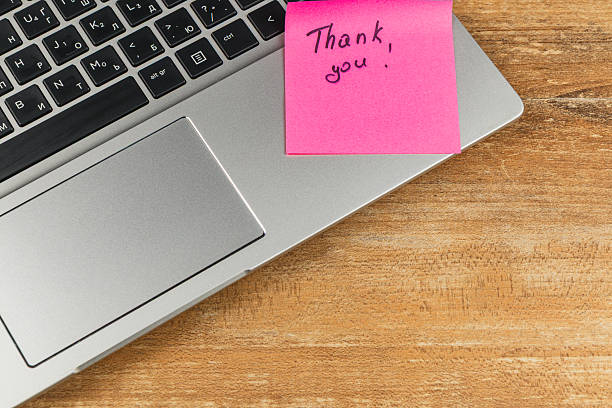 istock Note on laptop expressing gratitude placed on wooden desk 2242874690
