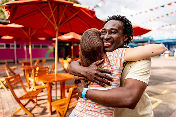 istock Couple sharing warm embracing at amusement park 2242875750