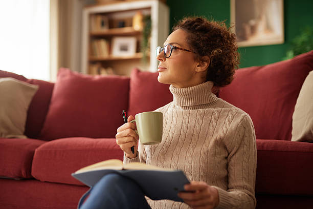 istock Woman sitting on floor journaling and thinking 2242879783