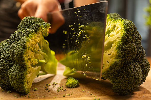 istock Fresh Broccoli Cut With Knife On Wooden Board, Rustic Home Kitchen Cooking Scene 2242881270