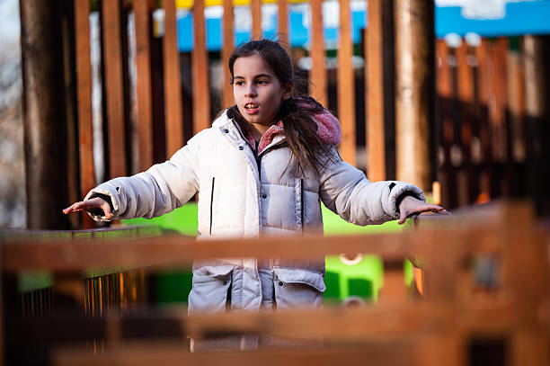 istock Young girl playing on a public playground 2242881987