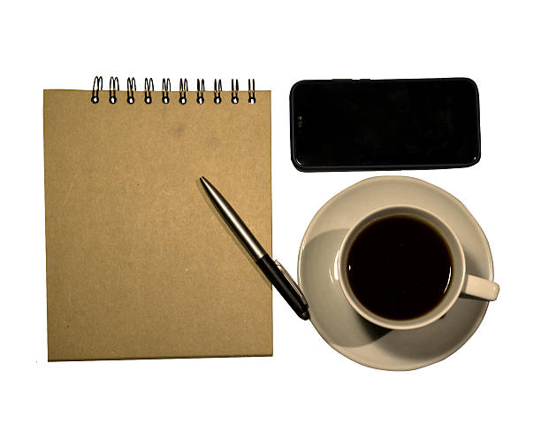 Cup of coffee, notepad, phone, pen isolated on white background