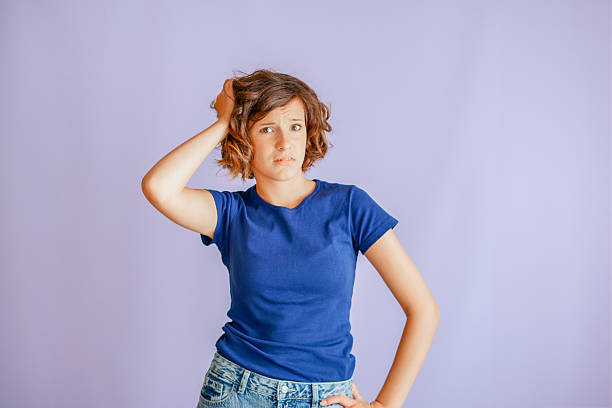 istock Concerned young girl expressing disagreement with troubled expression and stressed vibe for mental health concepts on vibrant blue studio background with anxious energy 2242883144