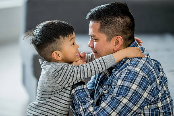 istock Dad And Son Share Warm Embrace At Home, Expressing Love, Bond, And Joy 2242883837