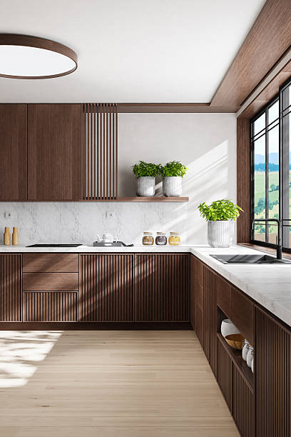 istock Luxury Dark Oak Kitchen with Marble Surfaces and Natural Light 2242885719