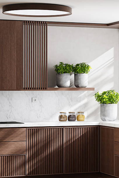 istock Luxury Dark Oak Kitchen with Marble Surfaces and Natural Light 2242885785