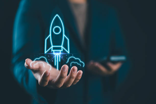 istock Businessman holding a holographic rocket launching above their hands, symbolizing innovation and startup success. 2242886401