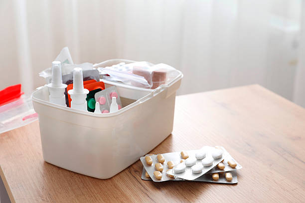 istock First aid kit and medicaments on wooden table indoors, closeup. Space for text 2242890865