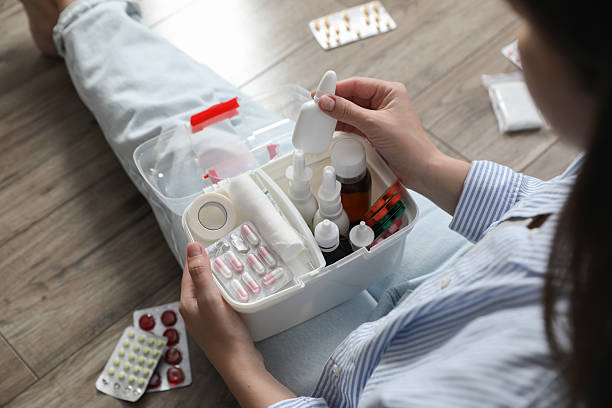 istock Woman putting medicament into first aid kit indoors, above view 2242890877