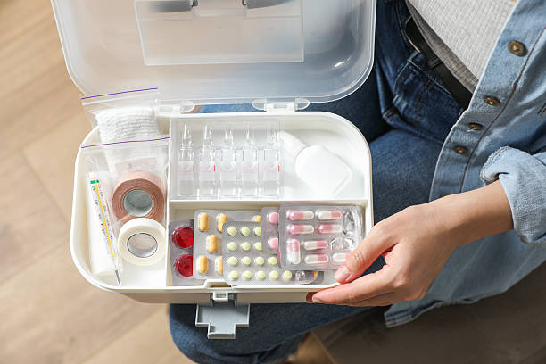 istock Woman holding first aid kit indoors, top view 2242890879