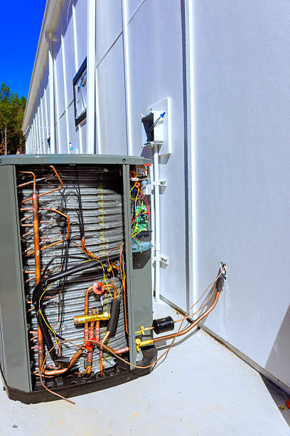 istock Repair work on an outdoor HVAC unit reveals internal components facility 2242897305