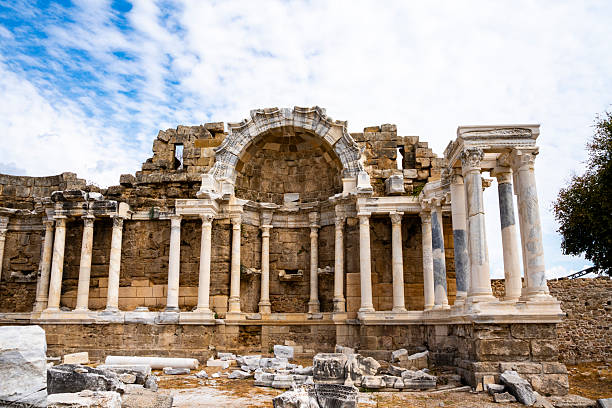 The Monumental Fountain (Nymphaeum) at Side, Turkey was a large, three-story public fountain built in the 2nd century CE during the Roman period. Situated at the foot of the city's main street, it was adorned with marble, statues, niches, and Corinthian columns, fed by an aqueduct, and served as a social and engineering marvel. Today, it is a significant ruin at the archaeological site,