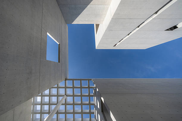 Looking up at the modern minimalist urban architecture with hollowed out ceilings.The building is the Pingtan International Performing Arts Center in Fujian Province, which is an outdoor public building.