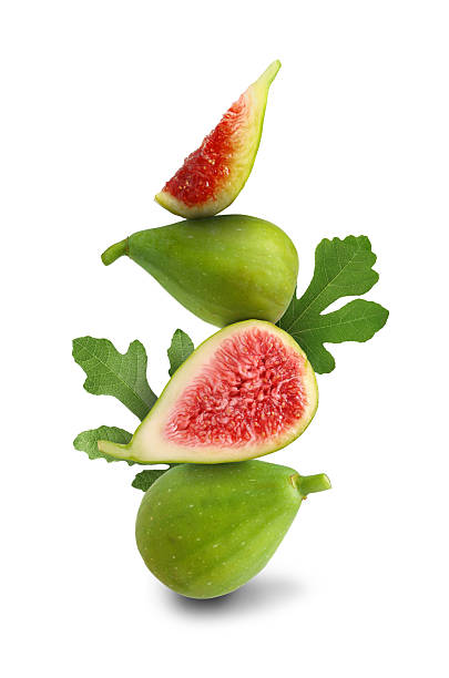 istock Stacked green figs and leaves on white background 2242903983