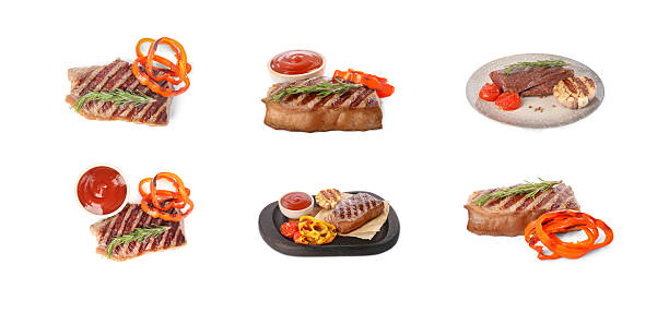 Delicious grilled beef steaks, vegetables and spices isolated on white, set