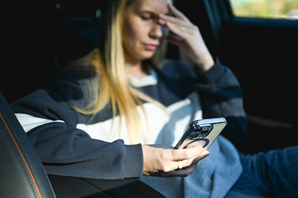 istock Woman feeling stressed inside car looking at smartphone 2242904209