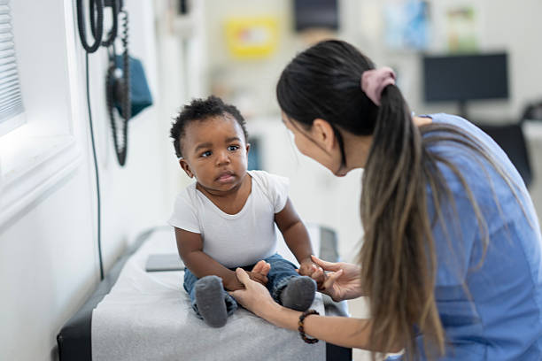 istock Caregiver Interacts Kindly With Infant During Medical Checkup In Clinic Setting 2242910752