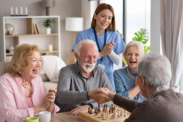 istock Seniors heaving handshake  over a chess match with laughter 2242911350