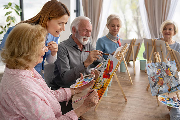 istock Senior citizens enjoying a colorful art class experience 2242911358