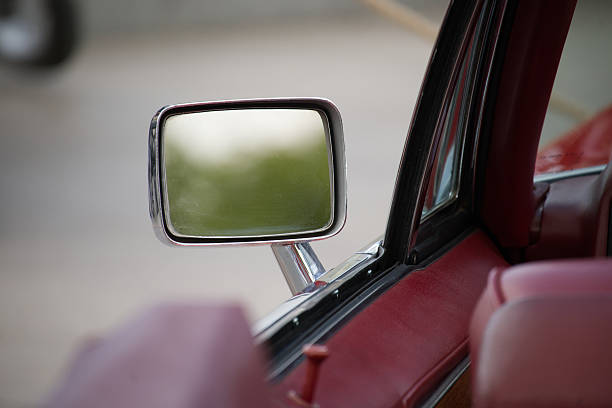istock Side Mirror View of a Classic Car with Vibrant Red Interior 2242913430