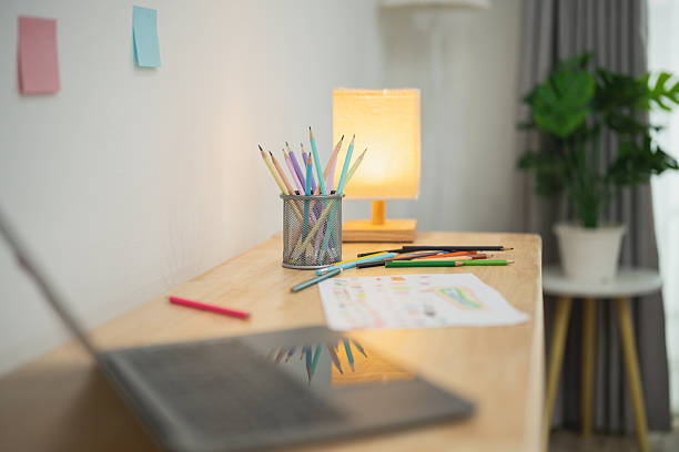 Cozy Workspace with Stationery, Laptop, and Natural Light in Modern Home Office Setting Featuring Creative Tools and Relaxing Atmosphere