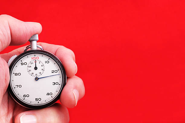 istock Stopwatch in hand over red background 2242919282