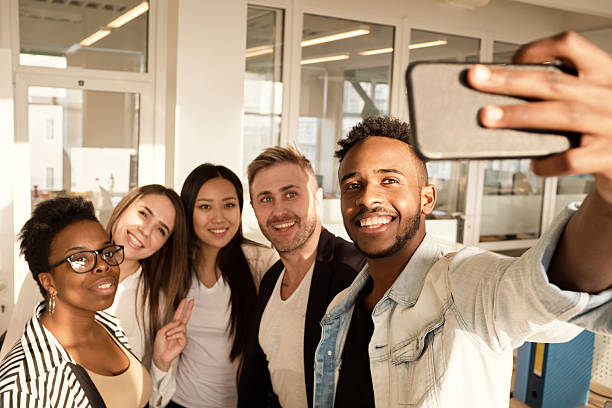 istock Group of Colleagues Taking Selfies in Office 2242926872