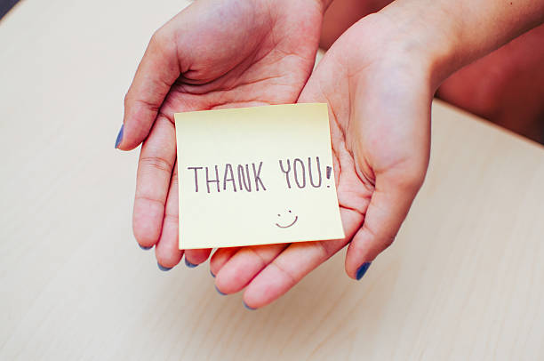 happy caucasian girl smiling, showing thank you, namaste gesture, grateful, standing over yellow background
