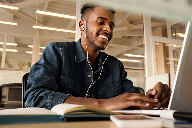 istock Young Man Talking on Video on Laptop at Office 2242933538